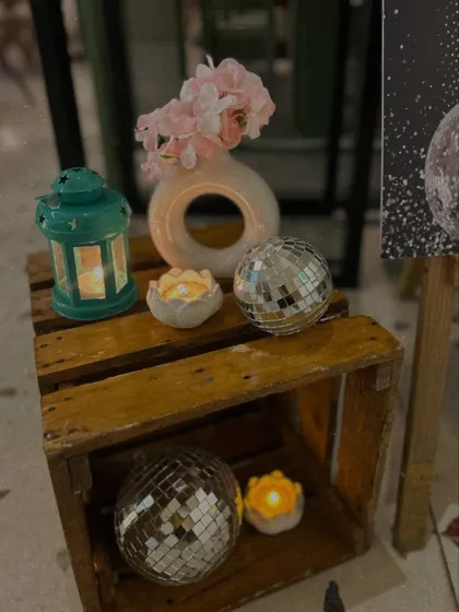 Small decorative corners add to the overall ambiance. Here, we used wooden crates, disco balls, and candles to create a rustic-glam vignette.