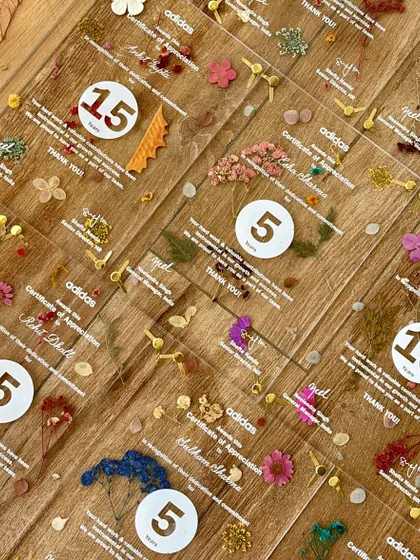 These acrylic certificates of appreciation for Adidas were a labor of love. Each piece features pressed flowers, screen-printed text, and custom calligraphy addressing to honor employees' years of dedication.