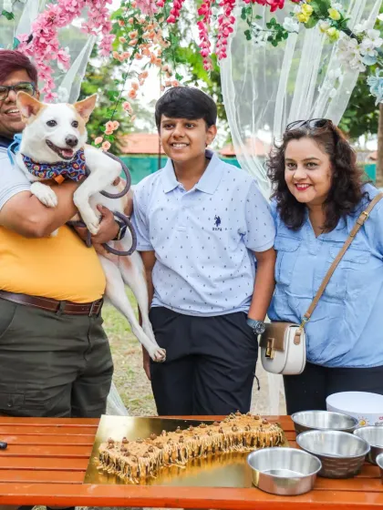 A family poses proudly with their indie dog at the Barkday Bash. We celebrate all dogs equally, and it's heartwarming to see our indie friends being pampered.