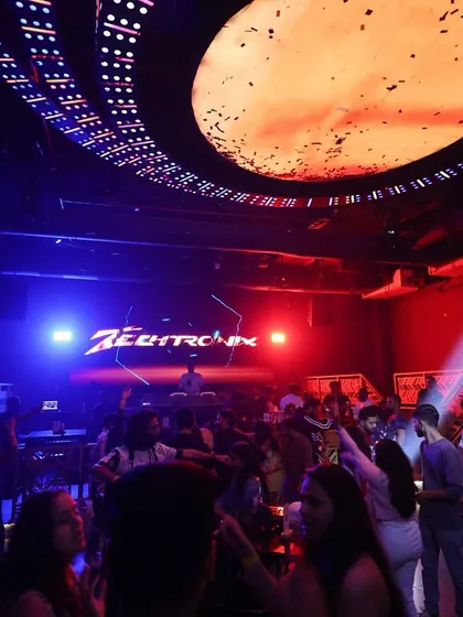 A wide shot of a packed club night. My visuals are a key part of the experience, creating an immersive atmosphere that complements the music.
