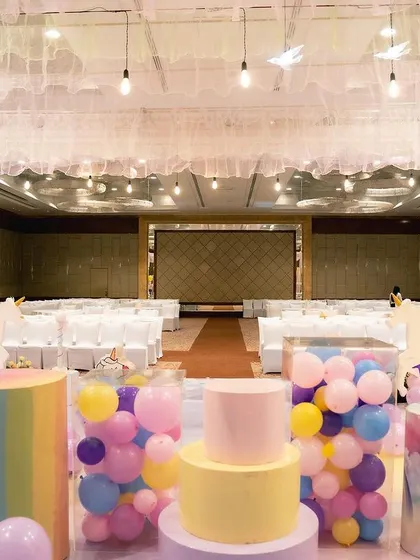 A behind the scenes look at the making of the unicorn party. You can see my team setting up the drapes, props, and long guest tables, transforming an empty hall into a fantasy land.