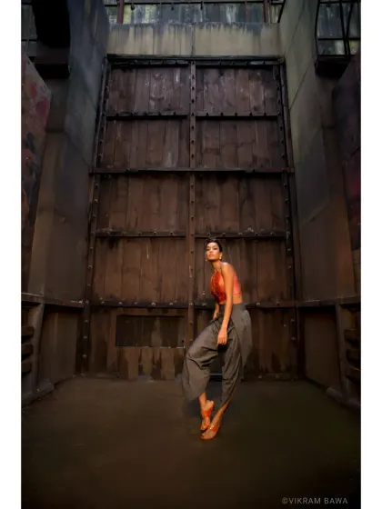 Only the best are always in motion. A dynamic shot of Lisa Haydon for a designer lookbook, set against a dramatic, industrial backdrop.