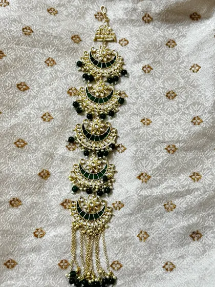 A Kundan hair choti with green Meenakari work and black bead drops. This rental accessory is designed to match my green bridal sets.