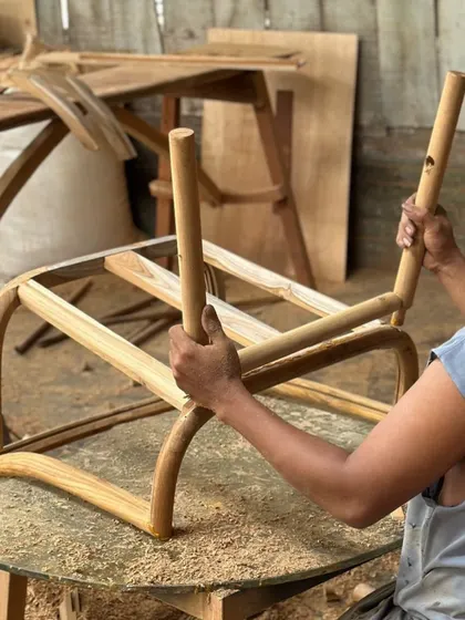 Here you can see the hands-on process at my Mumbai workshop. An artisan is carefully assembling the frame of a chair, showcasing the traditional joinery and attention to detail that goes into every piece I make.