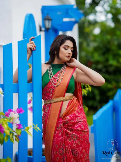 A playful and stylish shot of Sonal. The modern styling of the saree with a belt and jacket shows its versatility.