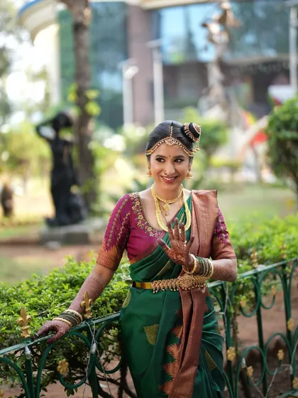 Ganashree on her wedding day, showcasing a beautiful Iyengar saree drape. I am experienced in various regional draping styles, including the traditional Madisar.