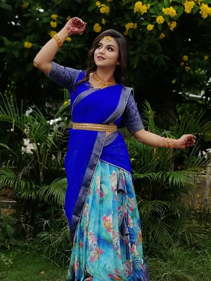 A client posing gracefully in a royal blue Langa Davani with a modern floral print skirt.