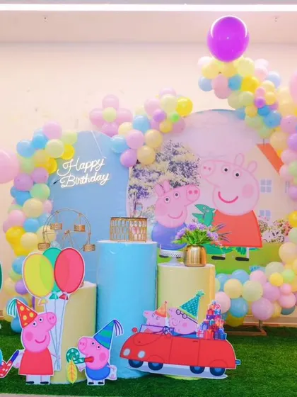 Oink oink! A playful Peppa Pig theme for Adrija's 3rd birthday party. We used a pastel balloon arch, character cutouts of Peppa and her family, and a light-up number "3" to create a fun scene right out of the cartoon.