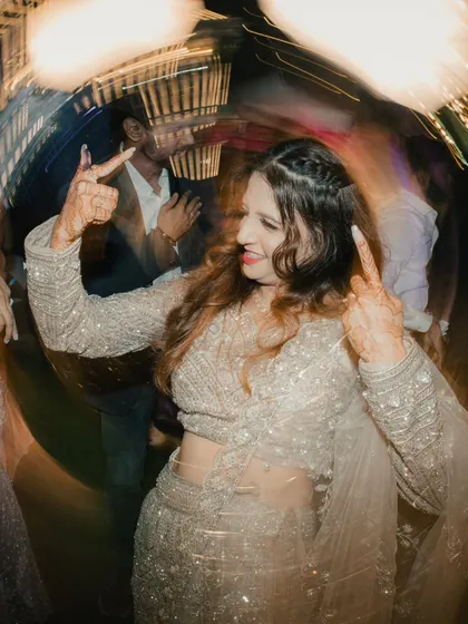 Capturing the fun on the dance floor. This creative shot with a circular blur effect focuses on the bride enjoying her engagement party.