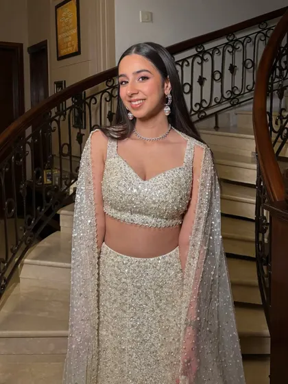The sister of the bride serving main character energy. We went for a full glam look with shimmer, soft pink tones, and a sharp winged eyeliner to match her sparkling Manish Malhotra outfit.