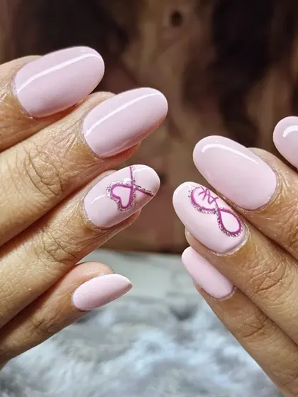 A simple and sweet design featuring oval-shaped nails in a soft pink shade. For the accent nails, I hand-painted a delicate infinity heart symbol, showing how we can add a personal touch to any set.