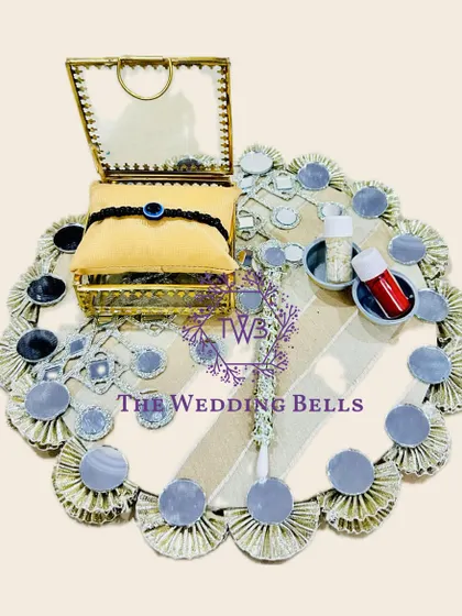 For a modern and chic vibe, this Rakhi tray with mirror work is a perfect choice. It's elegant and reflects the festive spirit beautifully.