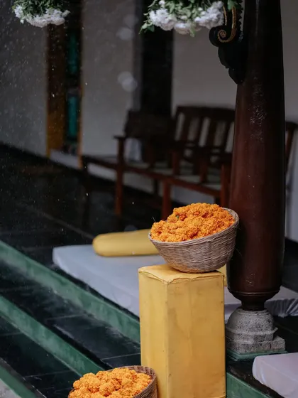 Even a sudden rain shower adds to the beauty of the day. Here, marigold-filled baskets sit on the steps, with raindrops creating a glistening, romantic effect.