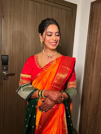 A close-up on the soft glam makeup. The eyes are subtly defined, and the skin is fresh and glowing, perfect for a traditional Marathi wedding.
