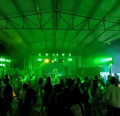 The entire venue is washed in green light, creating an immersive experience.
