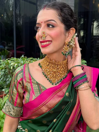For the Ganpati festival, I created this traditional Maharashtrian look for myself. The bold red lip, classic nath, and gajra bun celebrate our rich culture. We love creating authentic, radiant looks for all your festive occasions.