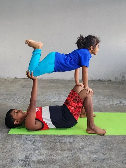 The joy on the base's face is priceless. Acro-yoga is as much about fun and connection as it is about fitness.
