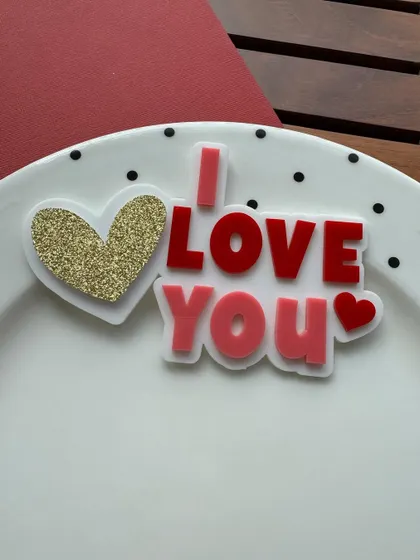 "I Love You." This layered acrylic charm with a gold glitter heart is a perfect declaration of love for Valentine's Day.