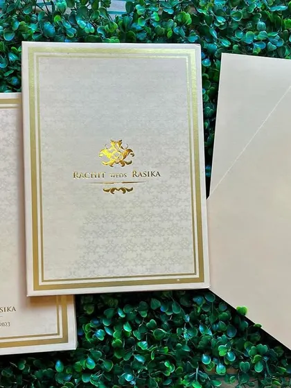 Another view of our elegant beige invitation set, showing the main card, folder, and inserts.