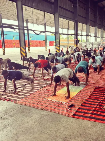 The workers moving through a flow together. It was the first time they stopped operations for a wellness session, and their enthusiasm was inspiring.