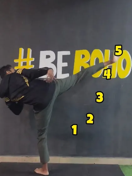 A member practicing a high side kick against our #BeBoho wall. This demonstrates the flexibility, balance, and power we cultivate in our classes.
