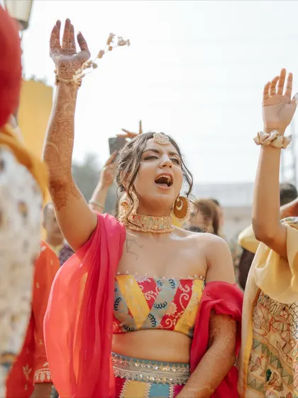 The bride dancing with pure abandon, her energy radiating throughout the Haldi ceremony.