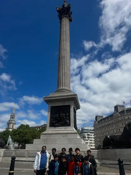 The team posing at Nelson's Column in Trafalgar Square, London.