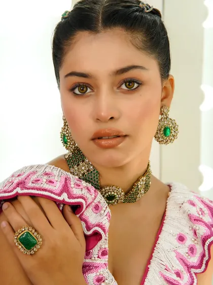 A direct and captivating gaze from the model, her makeup enhancing her striking features.