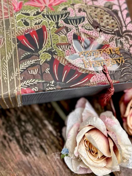 The smallest details make the biggest difference. This custom trousseau box features a beautiful floral print, complemented by a personalized acrylic name tag that adds a modern and bespoke touch to the entire gift.