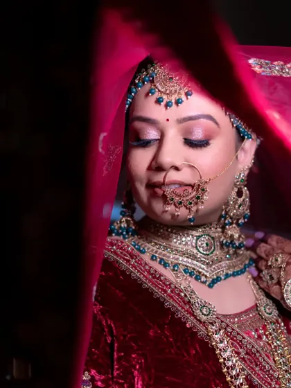 A dreamy shot under the veil. The makeup looks soft and ethereal, perfect for these classic bridal portraits.