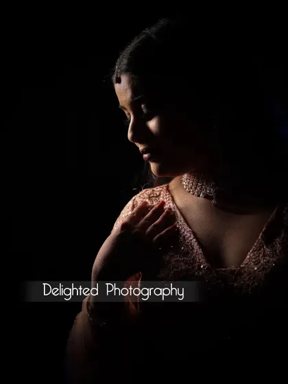 A pensive and artistic bridal portrait in profile. The use of shadow and light sculpts her features beautifully, creating a timeless and classic look.