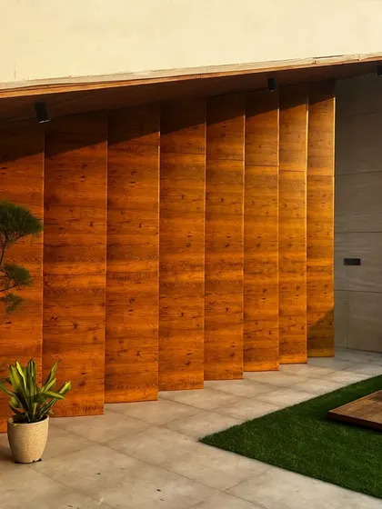 The start of a transformation. This image shows the bare wooden paneling and artificial turf on a Faridabad terrace, ready for the addition of furniture and plants.