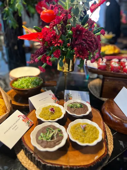 A selection of our house-made salsas, including a Pineapple Jalapeno Salsa and a classic bean dip. We serve them on rustic wooden platters to enhance the authentic fiesta feel.