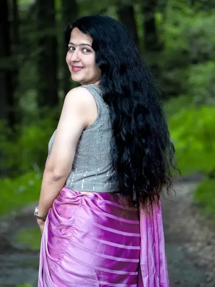 A beautiful shot of the bride-to-be looking back over her shoulder. Her long, flowing hair and the natural forest path create a lovely, romantic image.