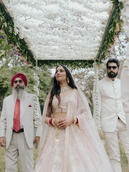 The bride, Amreet, looking serene and majestic as she stands with her father and brother before the ceremony. A powerful family moment.