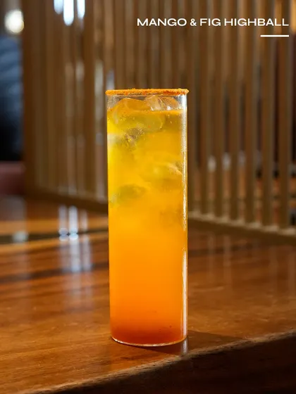 The Mango & Fig Highball, a rich and fruity highball with a spicy rim.