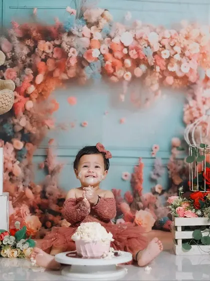 A first birthday is a huge milestone. This cake smash session, set against a beautiful floral backdrop, is all about celebrating that 'one-derful' year with joy, smiles, and a little bit of sweet mess.