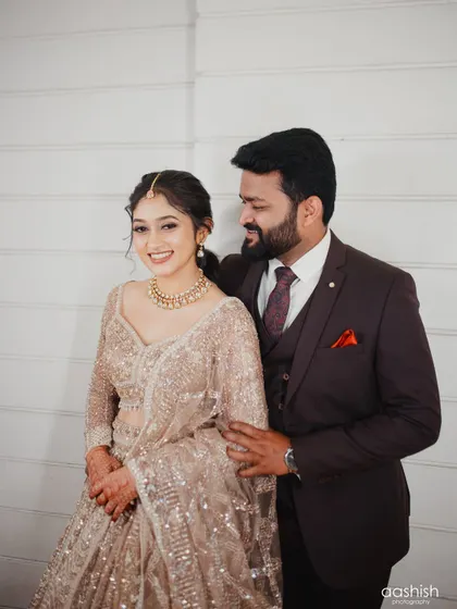 A happy and romantic couple portrait. The bride's makeup is soft and glowing, enhancing her natural beauty.