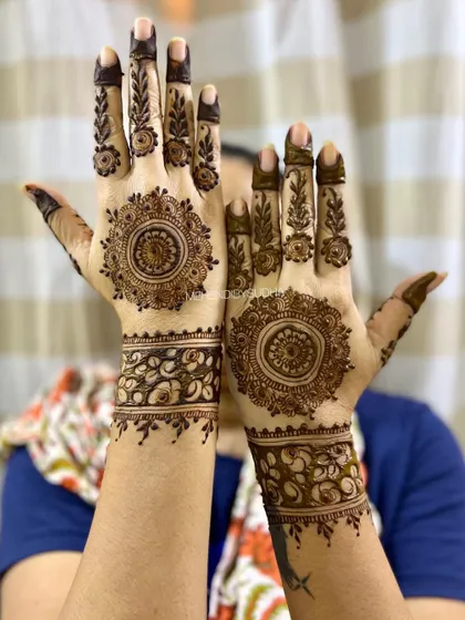 A happy client showing off her beautiful mandala mehendi. This style is timeless and suits every occasion.