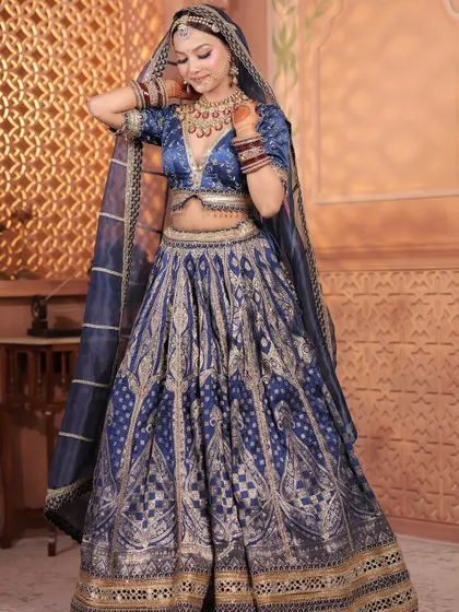 A stunning royal blue Banarasi lehenga, perfect for a bride who wants a rich, traditional look for her Sangeet or reception.