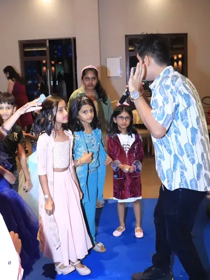 Getting the kids to participate in a game of 'Simon Says' at a Frozen party.