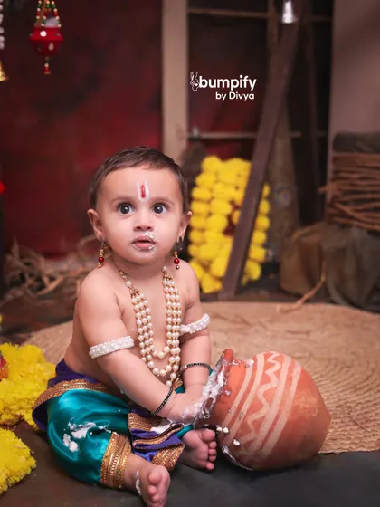 Caught in the act. This little Kanha has his hands and face covered in 'makkhan', making for a playful and authentic Janmashtami moment.