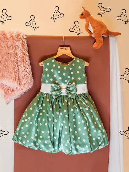 A graphic featuring a green polka dot dress, reminding you that sometimes simplicity and comfort are the most stylish choices of all.