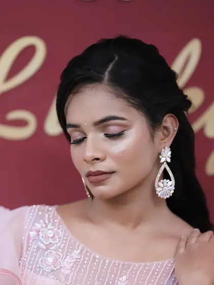 A close-up of a beautiful soft glam look, with shimmery pink eyeshadow and a flawless, glowing complexion. Perfect for an evening event.