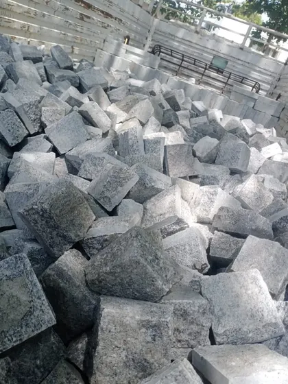 A truck bed filled with grey cobblestones, showing a typical bulk delivery.