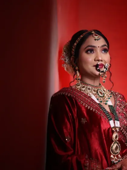 This stunning bride in her red lehenga is a perfect example of a classic North Indian bridal look. We focused on radiant skin, bold eyes, and a traditional bridal bun adorned with flowers.