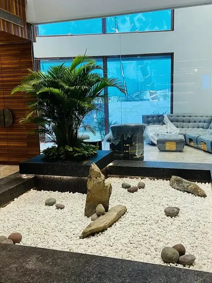 From this angle, you can see how the glass walls of the home look out onto the Zen garden, making it a central feature of the living space.