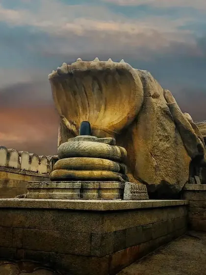 The unique Nagalingeshwara sculpture in Hampi, where a Shiva Linga is sheltered by a seven-headed cobra carved from a single rock.