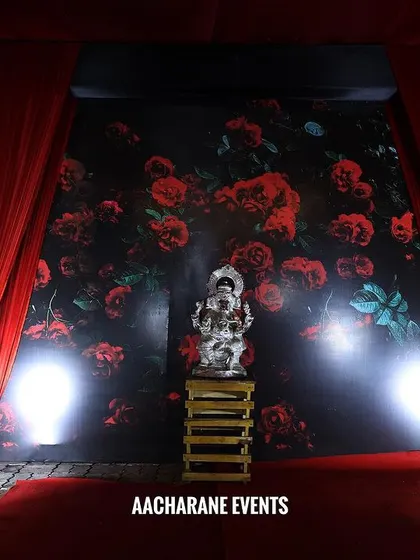 At the end of the red carpet walkway, I placed a Ganesha idol for blessings, set against a floral printed backdrop. This combines modern presentation with a touch of tradition.