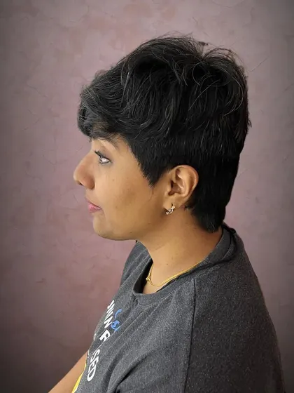 The side profile of the thick hair pixie, showing the clean lines and texture.